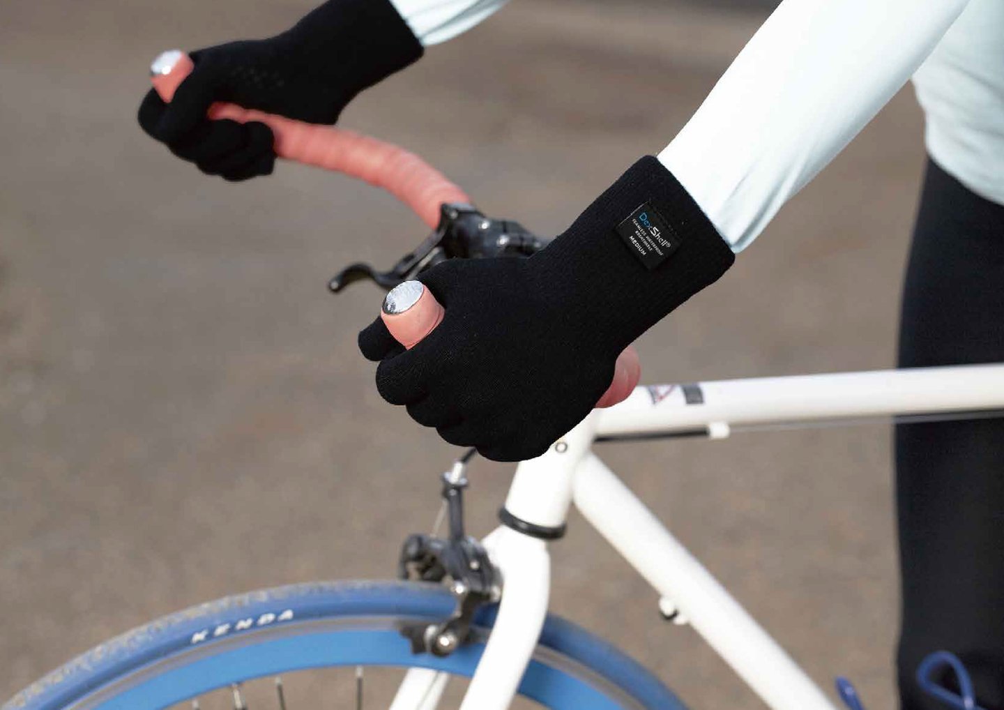 Cyclist wearing black waterproof gloves