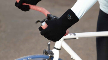 Cyclist wearing black waterproof gloves